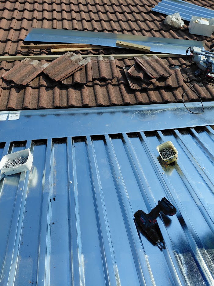 Headwall flashing installation in progress